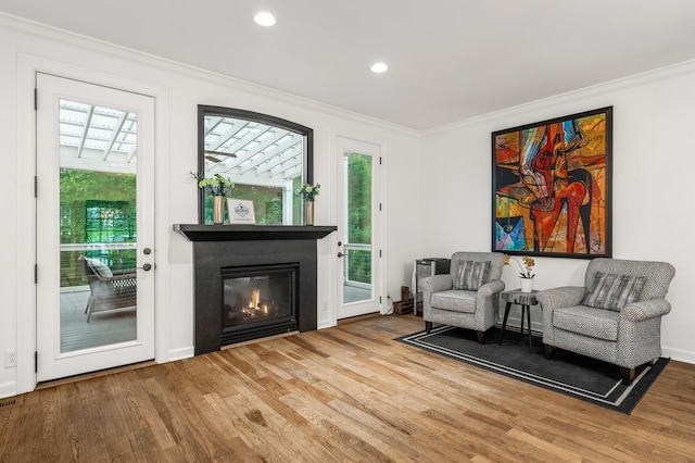 7871 Oscar Green Rd, Primm Springs, TN 38476 - sitting room featuring crown molding, wood finished floors, a glass covered fireplace, and recessed lighting