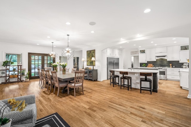 7871 Oscar Green Rd, Primm Springs, TN 38476 - dining space featuring arched walkways, light wood-type flooring, recessed lighting, crown molding, and a chandelier