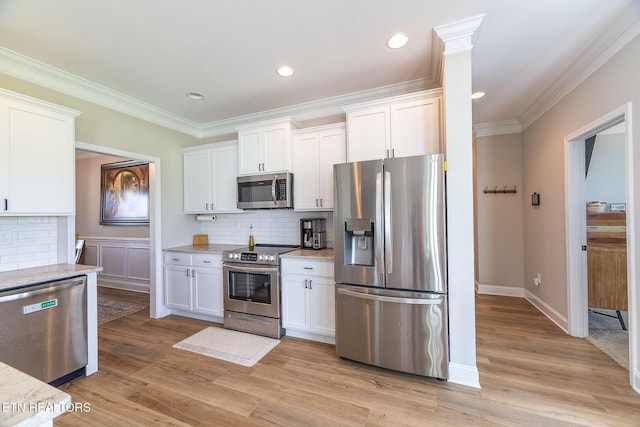 102 Chaseberry Rd, Oak Ridge, TN 37830 - kitchen featuring appliances with stainless steel finishes, white cabinets, decorative backsplash, crown molding, and light wood finished floors