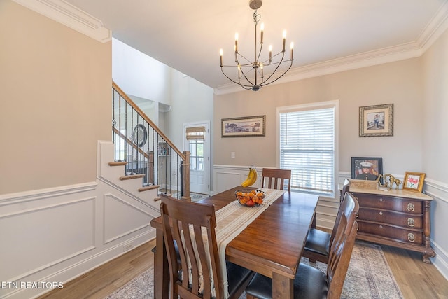 102 Chaseberry Rd, Oak Ridge, TN 37830 - dining space with a chandelier, wood finished floors, crown molding, a decorative wall, and stairs