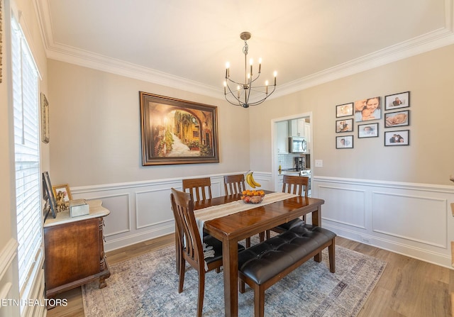 102 Chaseberry Rd, Oak Ridge, TN 37830 - dining room featuring crown molding, a chandelier, plenty of natural light, light wood-style floors, and a decorative wall