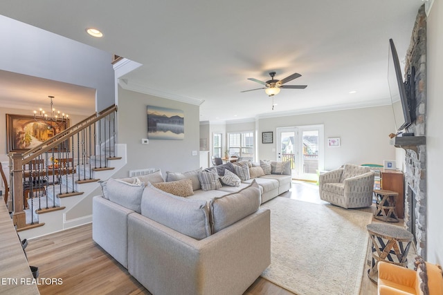 102 Chaseberry Rd, Oak Ridge, TN 37830 - living room with ornamental molding, light wood-style floors, stairway, a ceiling fan, and a chandelier