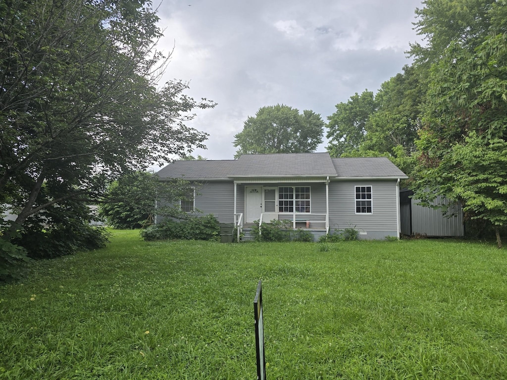 506 3rd St, Lawrenceburg, TN 38464 - view of front of property featuring a front lawn, a storage shed, and a porch