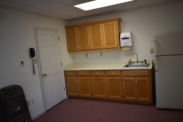 742 Lancaster Hwy, Lancaster, TN 38569 - kitchen with freestanding refrigerator, brown cabinetry, a paneled ceiling, light countertops, and dark colored carpet