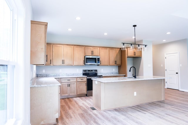 505 Depot St, Chapel Hill, TN 37034 - kitchen with stainless steel appliances, light wood finished floors, a center island with sink, light stone countertops, and recessed lighting