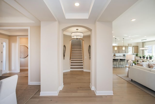 1935 Harmony Rd, Spring Hill, TN 37174 - foyer featuring arched walkways, light wood-style flooring, stairway, a tray ceiling, and recessed lighting