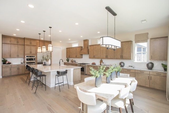 1935 Harmony Rd, Spring Hill, TN 37174 - kitchen featuring custom exhaust hood, appliances with stainless steel finishes, brown cabinetry, decorative backsplash, and recessed lighting