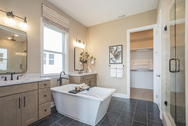 1935 Harmony Rd, Spring Hill, TN 37174 - bathroom featuring a stall shower, healthy amount of natural light, a freestanding tub, and two vanities
