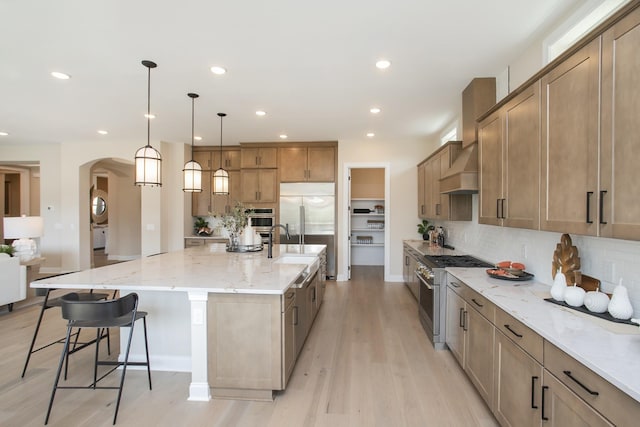 1935 Harmony Rd, Spring Hill, TN 37174 - kitchen featuring high quality appliances, backsplash, light wood finished floors, light stone countertops, and recessed lighting