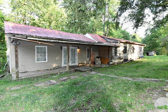 398 Elmore Town Rd, Baxter, TN 38544 - back of property featuring french doors, a lawn, and a metal roof