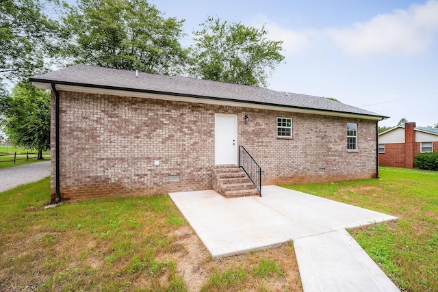 136 E School Dr, Rock Island, TN 38581 - rear view of property featuring entry steps, crawl space, brick siding, a lawn, and a patio
