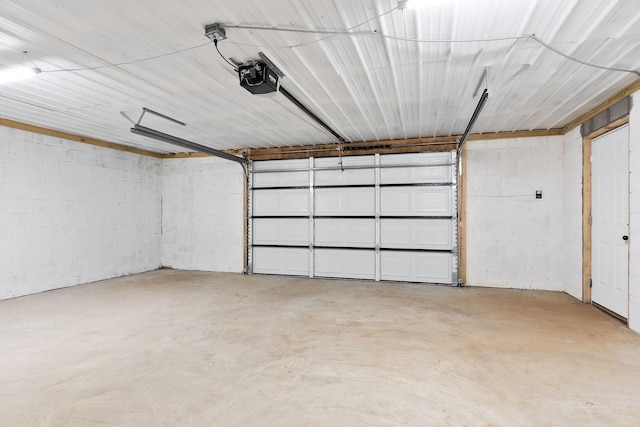 136 E School Dr, Rock Island, TN 38581 - garage featuring a garage door opener and concrete block wall