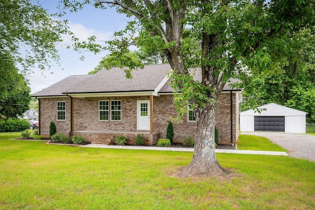 136 E School Dr, Rock Island, TN 38581 - view of front of property featuring an outdoor structure, a garage, a front yard, brick siding, and a shingled roof