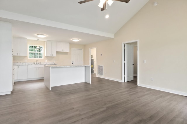 136 E School Dr, Rock Island, TN 38581 - kitchen with a kitchen island, white cabinetry, ceiling fan, wood finished floors, and high vaulted ceiling