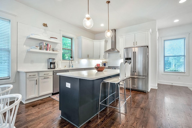 1510B 10th Ave N, Nashville, TN 37208 - kitchen featuring stainless steel appliances, wall chimney exhaust hood, backsplash, white cabinetry, and dark wood-type flooring