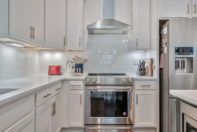 1510B 10th Ave N, Nashville, TN 37208 - kitchen with appliances with stainless steel finishes, wall chimney range hood, tasteful backsplash, light countertops, and white cabinets
