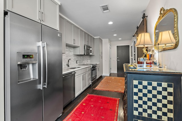 1212 Laurel St Unit 1510, Nashville, TN 37203 - kitchen featuring stainless steel appliances, dark wood finished floors, recessed lighting, light countertops, and decorative backsplash