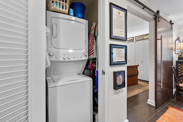 1212 Laurel St Unit 1510, Nashville, TN 37203 - washroom with stacked washer / dryer, wood finished floors, and a barn door
