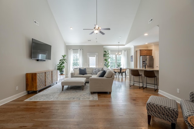 8624 Reba Ln, Hixson, TN 37343 - living room featuring high vaulted ceiling, a ceiling fan, hardwood / wood-style floors, and a chandelier