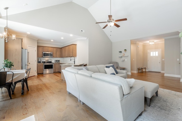 8624 Reba Ln, Hixson, TN 37343 - living room with high vaulted ceiling, light wood-style floors, a ceiling fan, a chandelier, and crown molding