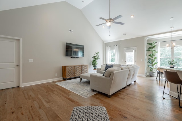 8624 Reba Ln, Hixson, TN 37343 - living area featuring high vaulted ceiling, ceiling fan, light wood finished floors, and a chandelier