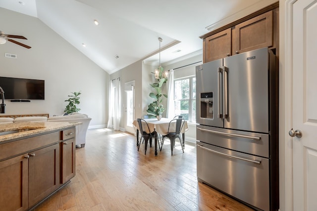 8624 Reba Ln, Hixson, TN 37343 - kitchen featuring high end fridge, light stone counters, lofted ceiling, ceiling fan, and light wood-type flooring