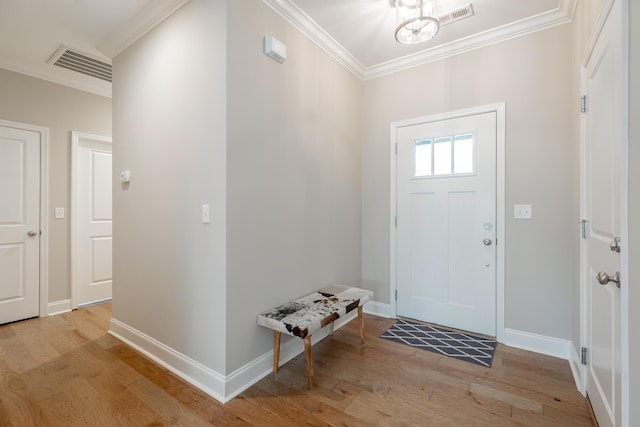 8624 Reba Ln, Hixson, TN 37343 - entrance foyer with light wood-style floors, ornamental molding, and a chandelier