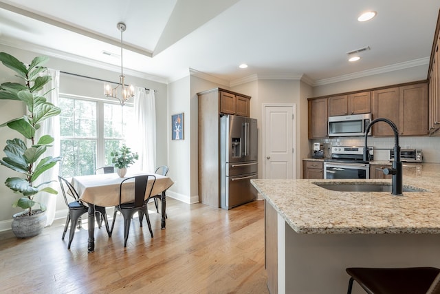 8624 Reba Ln, Hixson, TN 37343 - kitchen featuring stainless steel appliances, light stone counters, a chandelier, recessed lighting, and a peninsula