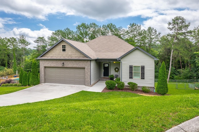 8624 Reba Ln, Hixson, TN 37343 - view of front of house featuring a garage, driveway, brick siding, and a shingled roof