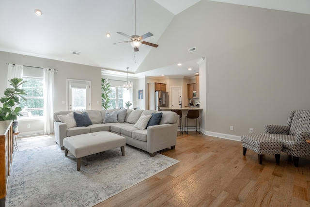 8624 Reba Ln, Hixson, TN 37343 - living area with vaulted ceiling, light wood finished floors, ceiling fan, a chandelier, and recessed lighting