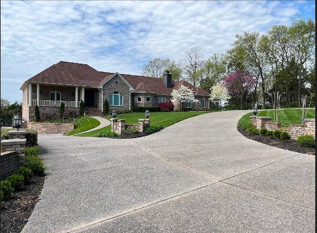 1825 Lake Meadow Trl, Mount Juliet, TN 37122 - ranch-style home with concrete driveway, covered porch, a front yard, a chimney, and brick siding