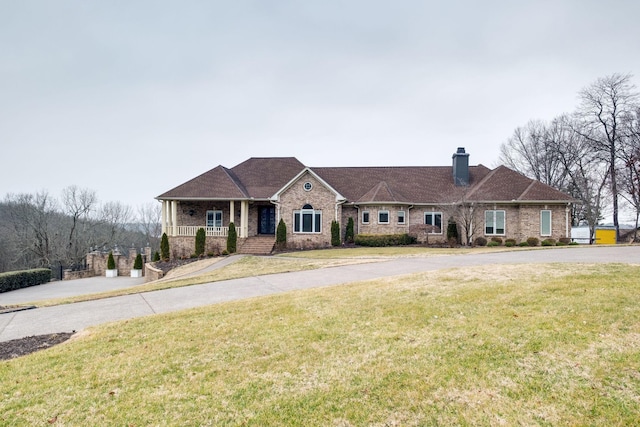 1825 Lake Meadow Trl, Mount Juliet, TN 37122 - view of front of house with a chimney, a porch, a front lawn, and brick siding