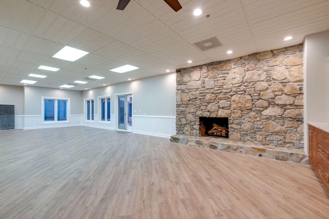 1825 Lake Meadow Trl, Mount Juliet, TN 37122 - unfurnished living room with a stone fireplace, wood finished floors, a wainscoted wall, ceiling fan, and recessed lighting