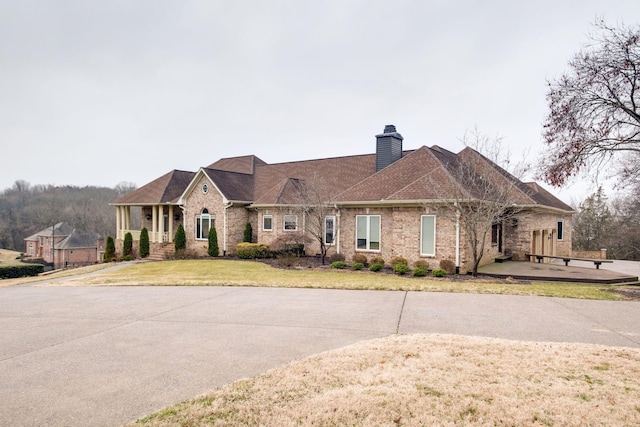 1825 Lake Meadow Trl, Mount Juliet, TN 37122 - view of front of house with a chimney, brick siding, and a front lawn