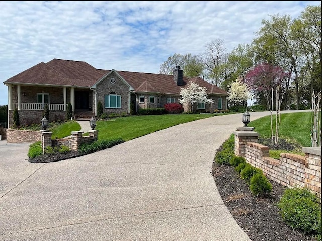 1825 Lake Meadow Trl, Mount Juliet, TN 37122 - view of front of home featuring a chimney, a front lawn, covered porch, and driveway