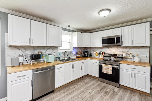330 Union Camp Rd, Lafayette, TN 37083 - kitchen featuring stainless steel appliances, wood counters, crown molding, white cabinets, and a textured ceiling