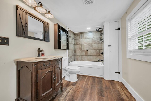 3328 Church St, Burns, TN 37029 - bathroom with wood finished floors, vanity, and shower / washtub combination