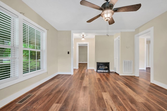 3328 Church St, Burns, TN 37029 - unfurnished living room with a wood stove, wood finished floors, and ceiling fan