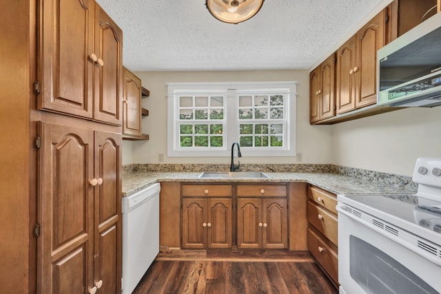 3328 Church St, Burns, TN 37029 - kitchen featuring white appliances, dark wood-type flooring, brown cabinetry, light stone countertops, and a textured ceiling