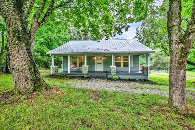 3328 Church St, Burns, TN 37029 - view of front of home with covered porch, a metal roof, and a front lawn