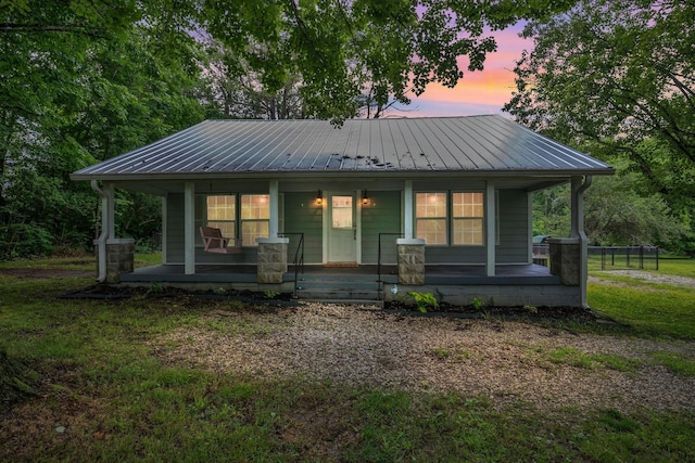 3328 Church St, Burns, TN 37029 - view of front facade with a porch, a metal roof, and a front lawn