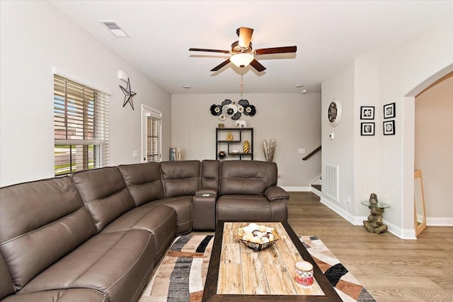 433 Longstone Rd, Gallatin, TN 37066 - living room with arched walkways, a ceiling fan, wood finished floors, and stairs