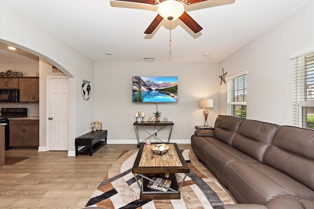 433 Longstone Rd, Gallatin, TN 37066 - living area featuring arched walkways, light wood finished floors, and a ceiling fan