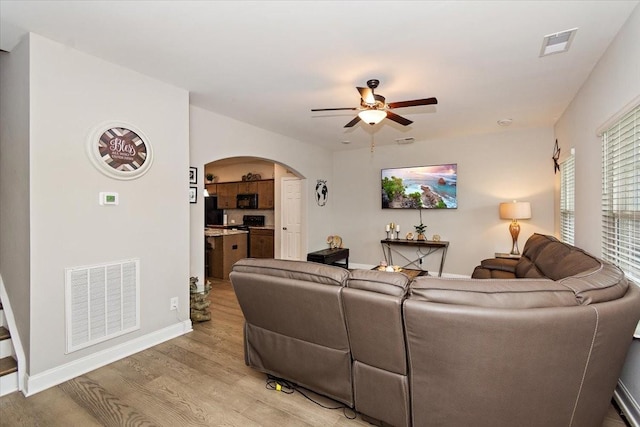 433 Longstone Rd, Gallatin, TN 37066 - living area with arched walkways, ceiling fan, and light wood finished floors