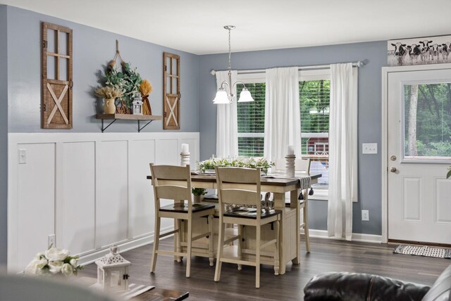 516 Cedarcrest Dr, Chapmansboro, TN 37035 - dining area featuring dark wood finished floors, a chandelier, and a wainscoted wall