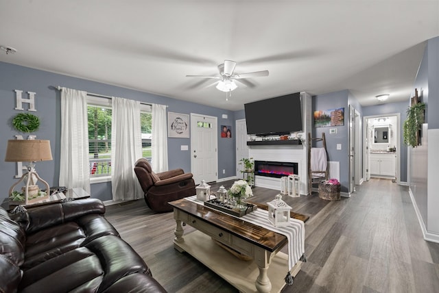 516 Cedarcrest Dr, Chapmansboro, TN 37035 - living room with ceiling fan, wood finished floors, and a glass covered fireplace