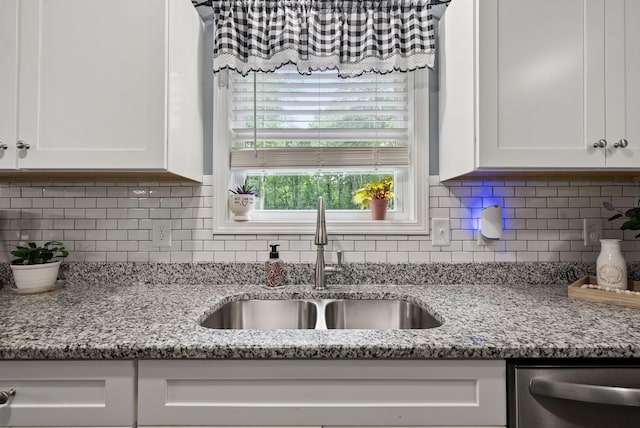516 Cedarcrest Dr, Chapmansboro, TN 37035 - kitchen with dishwasher, white cabinetry, light stone counters, and backsplash