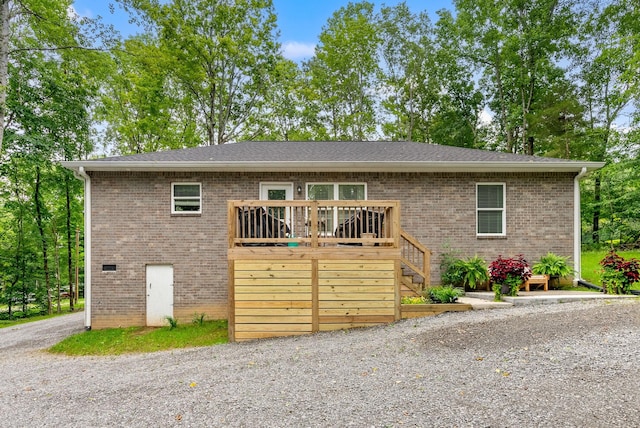 516 Cedarcrest Dr, Chapmansboro, TN 37035 - view of front of house with a deck, brick siding, and stairway
