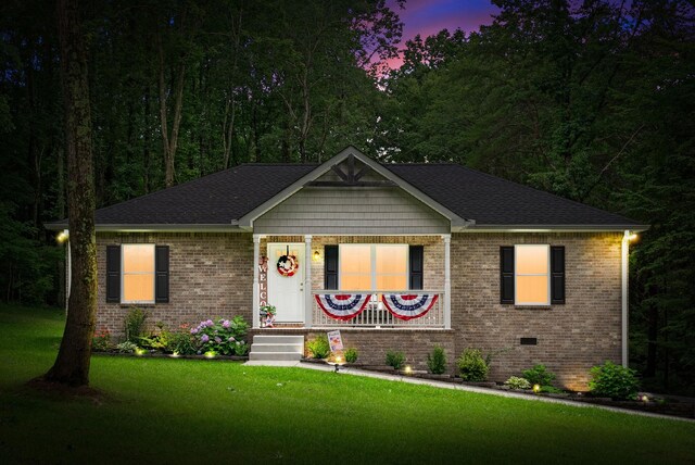 516 Cedarcrest Dr, Chapmansboro, TN 37035 - ranch-style home featuring brick siding, a front lawn, and a shingled roof
