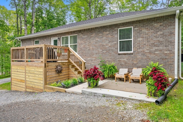 516 Cedarcrest Dr, Chapmansboro, TN 37035 - view of front of property featuring a deck, brick siding, and stairs